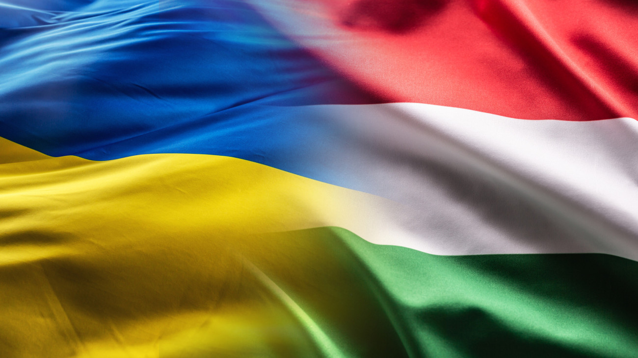 Hungarian and Ukrainian flags flutter together in the wind.